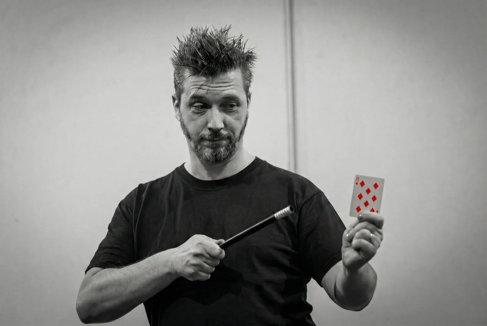 Performance still, holding a playing card